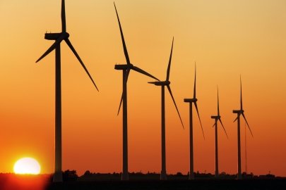 Wind turbines against a red sky