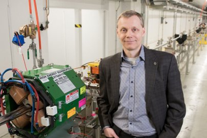 Director Sergei Nagaitsev stands in front of an accelerator beamline under construction at the Fermilab Accelerator Complex. 