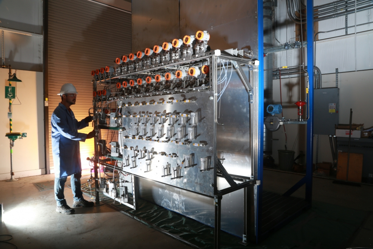 An engineer monitors a feed control system for a new, energy efficient pilot process for producing ethylene, one of the most energy-intensive and commonly manufactured chemicals.  