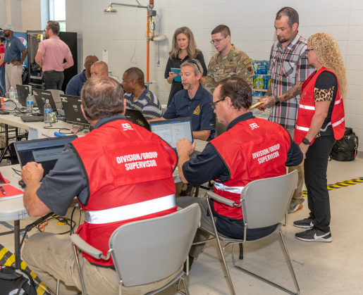 Exercise “controllers,” in the red vests, evaluated how “players” overcame various “injects” – or twists – in the Cobalt Magnet scenario. 