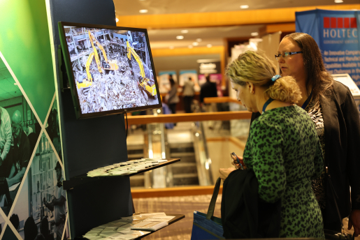 People interact with a booth display