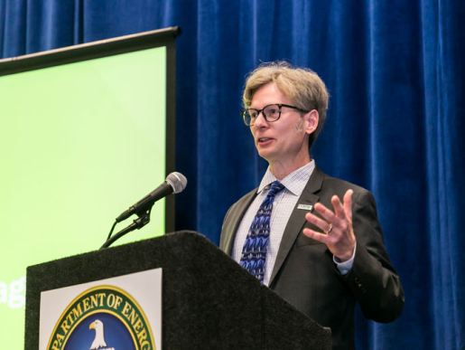 A person standing at the podium and speaking.
