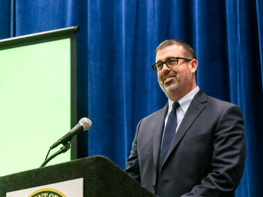 A person standing at a podium speaking.