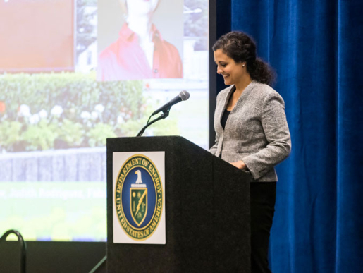 A person standing at a podium speaking.
