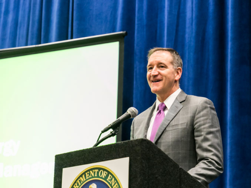 A person standing at a podium speaking.