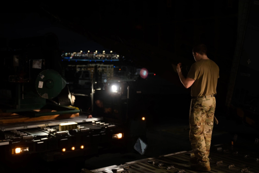 U.S. Air Force Staff Sgt. Brandon Whitley, 437th Aerial Port Squadron ramp services supervisor, guides a vehicle carrying U.S. Department of Energy equipment onto a C-5 Super Galaxy at Joint Base Charleston, South Carolina, Jan. 31, 2023. This critical equipment is part of a $53 million humanitarian package announced by the U.S. Secretary of State, endeavoring to offset continued Russian attacks on Ukraine’s energy infrastructure.