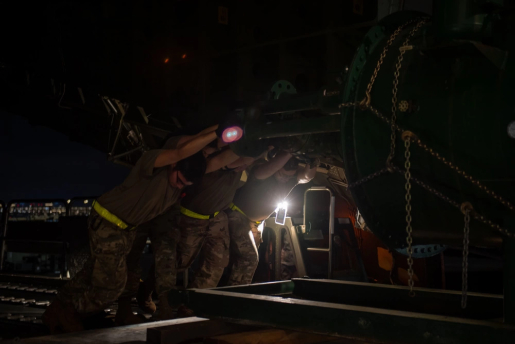 U.S. Airmen assigned to the 437th Aerial Port Squadron, push U.S. Department of Energy equipment onto a C-5 Super Galaxy at Joint Base Charleston, South Carolina, Jan. 31, 2023. The U.S. Air Force partnered with the DoE to deliver critical equipment to Ukraine in efforts to bolster the nation’s energy infrastructure. *photo was edited for security purposes*