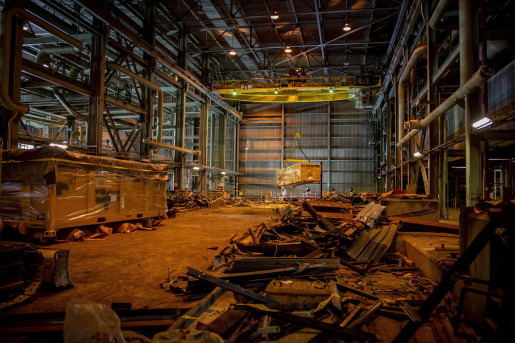 Warehouse with wood and other debris on the floor.