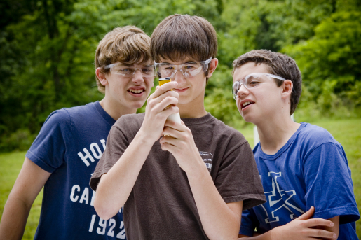 Middle school students look at a soil sample.
