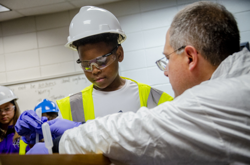 Student observes groundwater sample with instructor.
