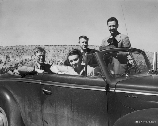 Young individuals in a Ford Deluxe car