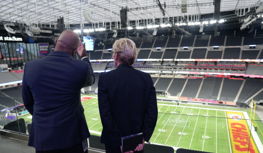 U.S. Secretary of Energy Jennifer Granholm and Chief Engineer of Allegiant Stadium Joseph Wright look out onto the football field at Allegiant—the first NFL stadium powered by 100% renewable energy.
