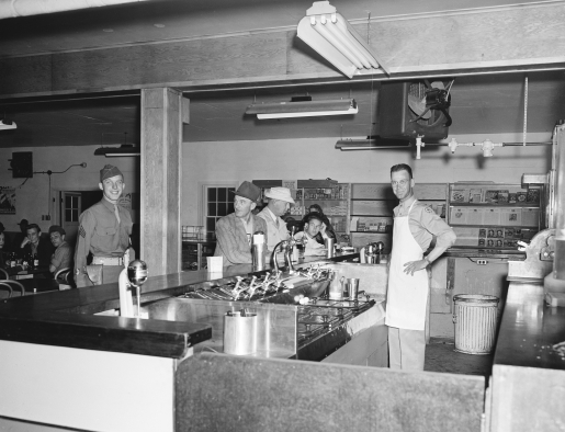 Men at soda bar counter