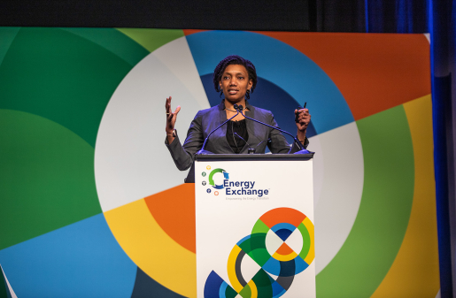 A person standing at a podium speaking to the audience (not pictured).