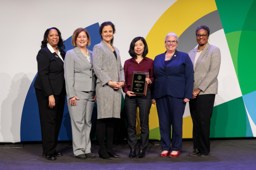 A group of individuals at an awards ceremony smiling at the camera.