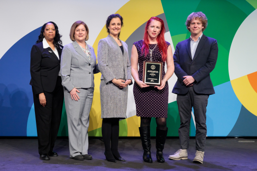 A group of individuals at an awards ceremony smiling at the camera.