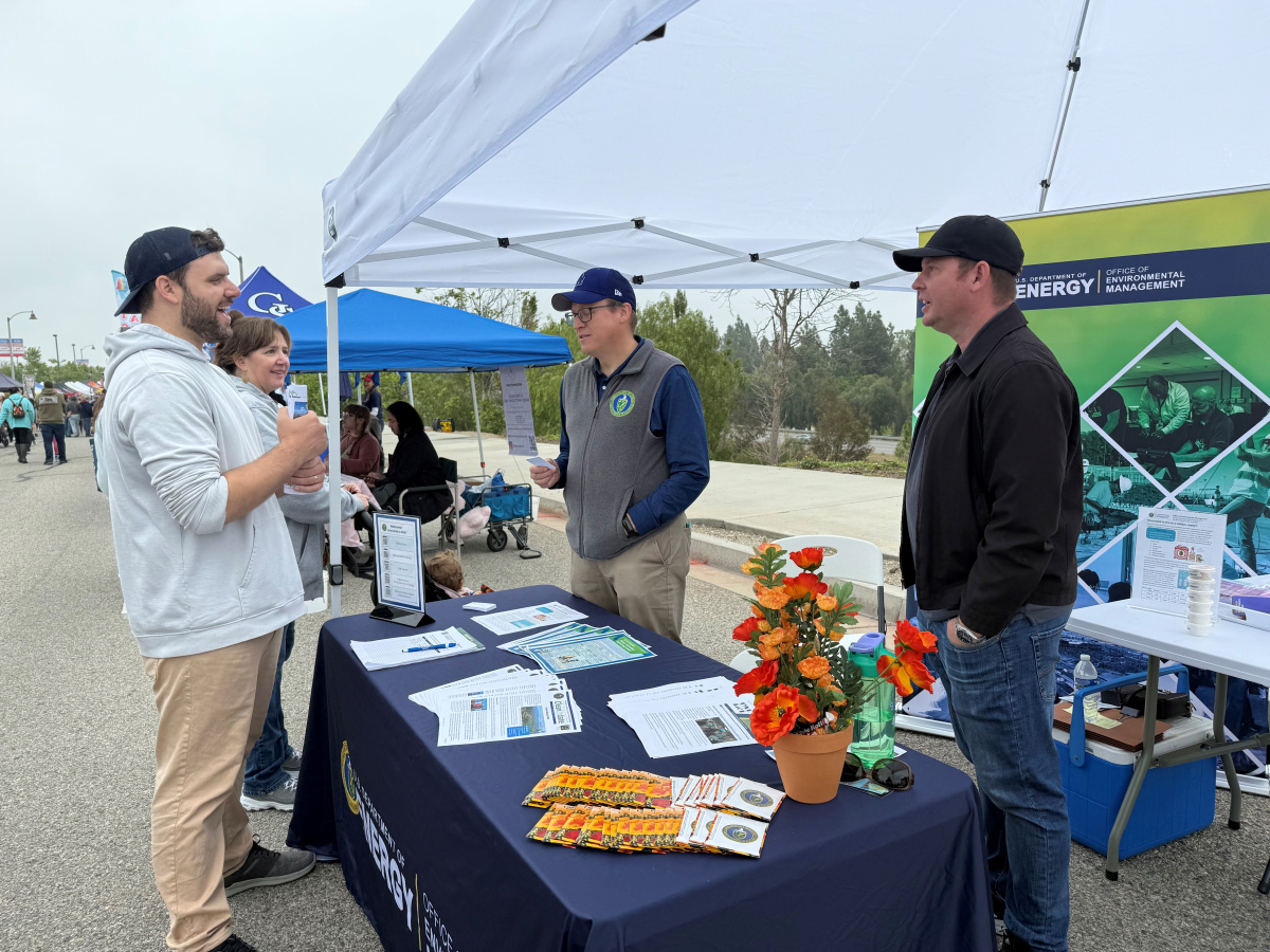 Employees and citizens at a street fair booth