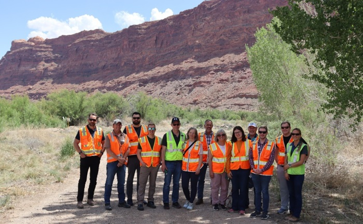 U.S. Rep. Mike Kennedy of Utah, third from left, and Grand County Commission Chair Bill Winfield, far right, at the Moab Project site rail bench overlook.