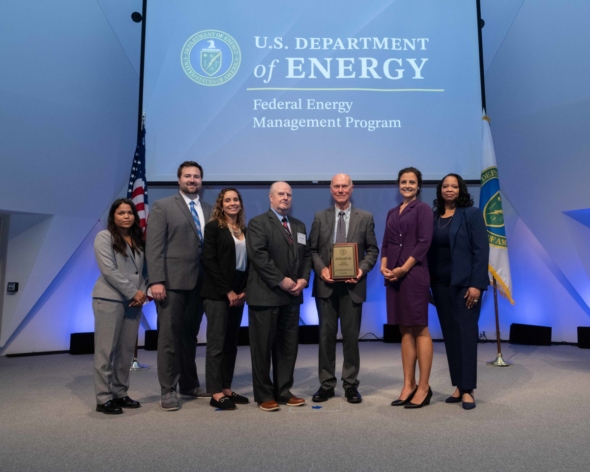 A group of people posing for a photo at the 2024 Federal Energy and Water Management Awards ceremony.