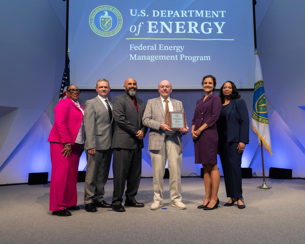 A group of people posing for a photo at the 2024 Federal Energy and Water Management Awards ceremony.