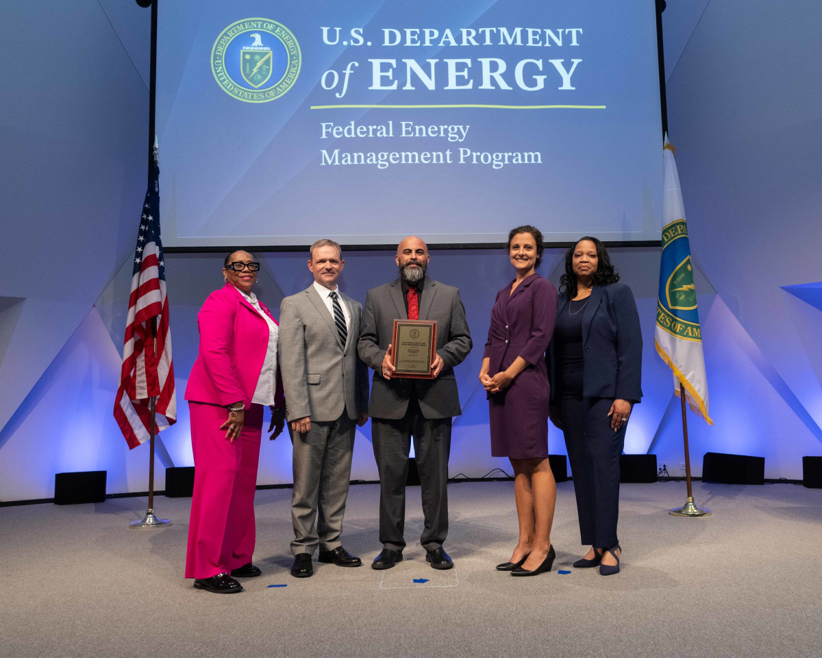 A group of people posing for a photo at the 2024 Federal Energy and Water Management Awards ceremony.
