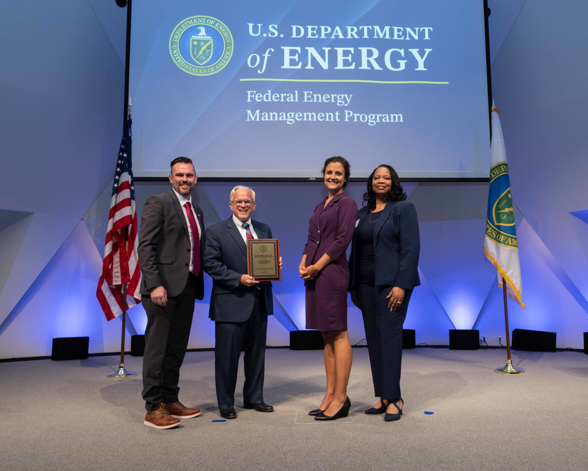 A group of people posing for a photo at the 2024 Federal Energy and Water Management Awards ceremony.