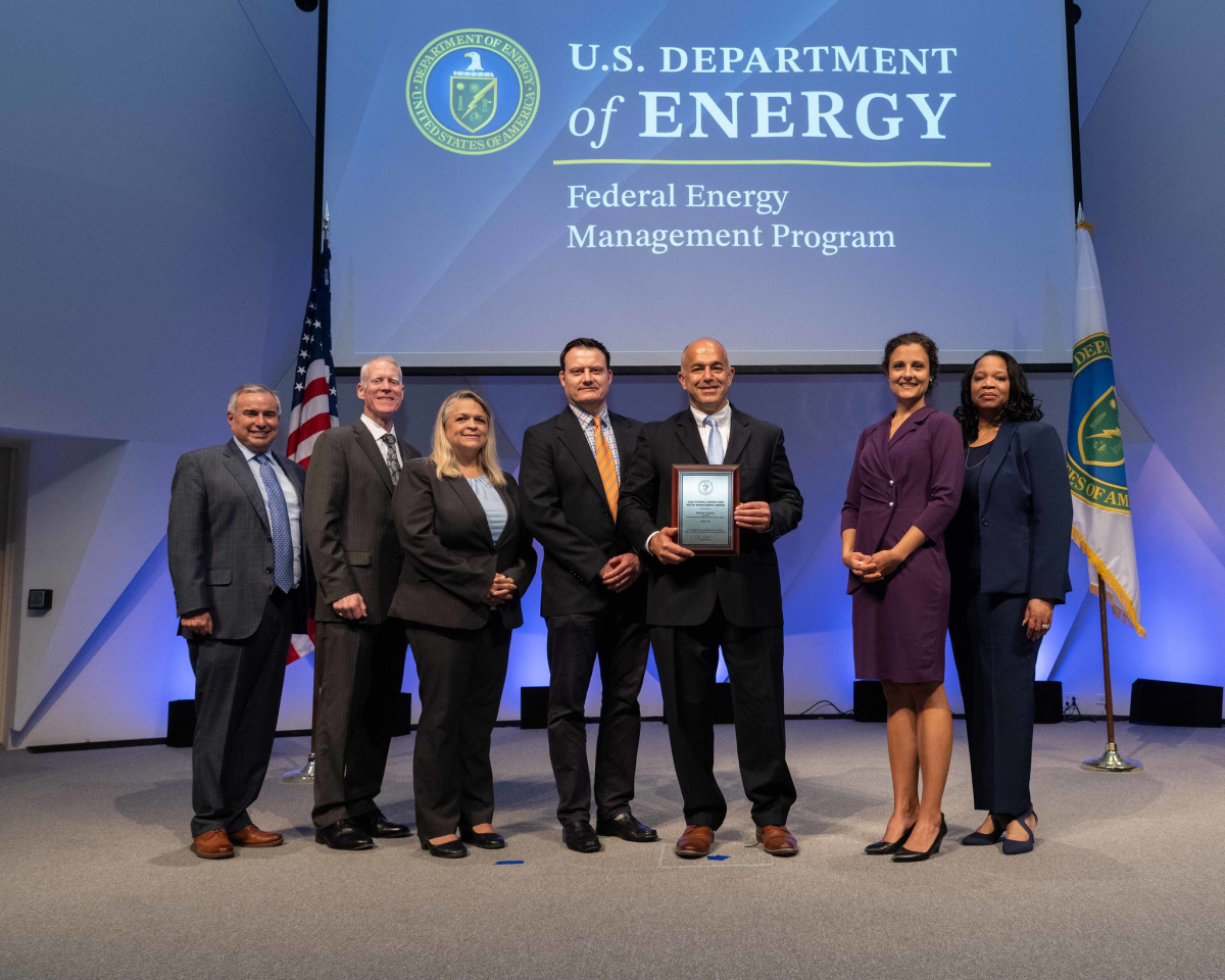 A group of people posing for a photo at the 2024 Federal Energy and Water Management Awards ceremony.