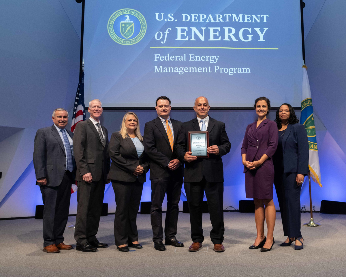 A group of people posing for a photo at the 2024 Federal Energy and Water Management Awards ceremony.