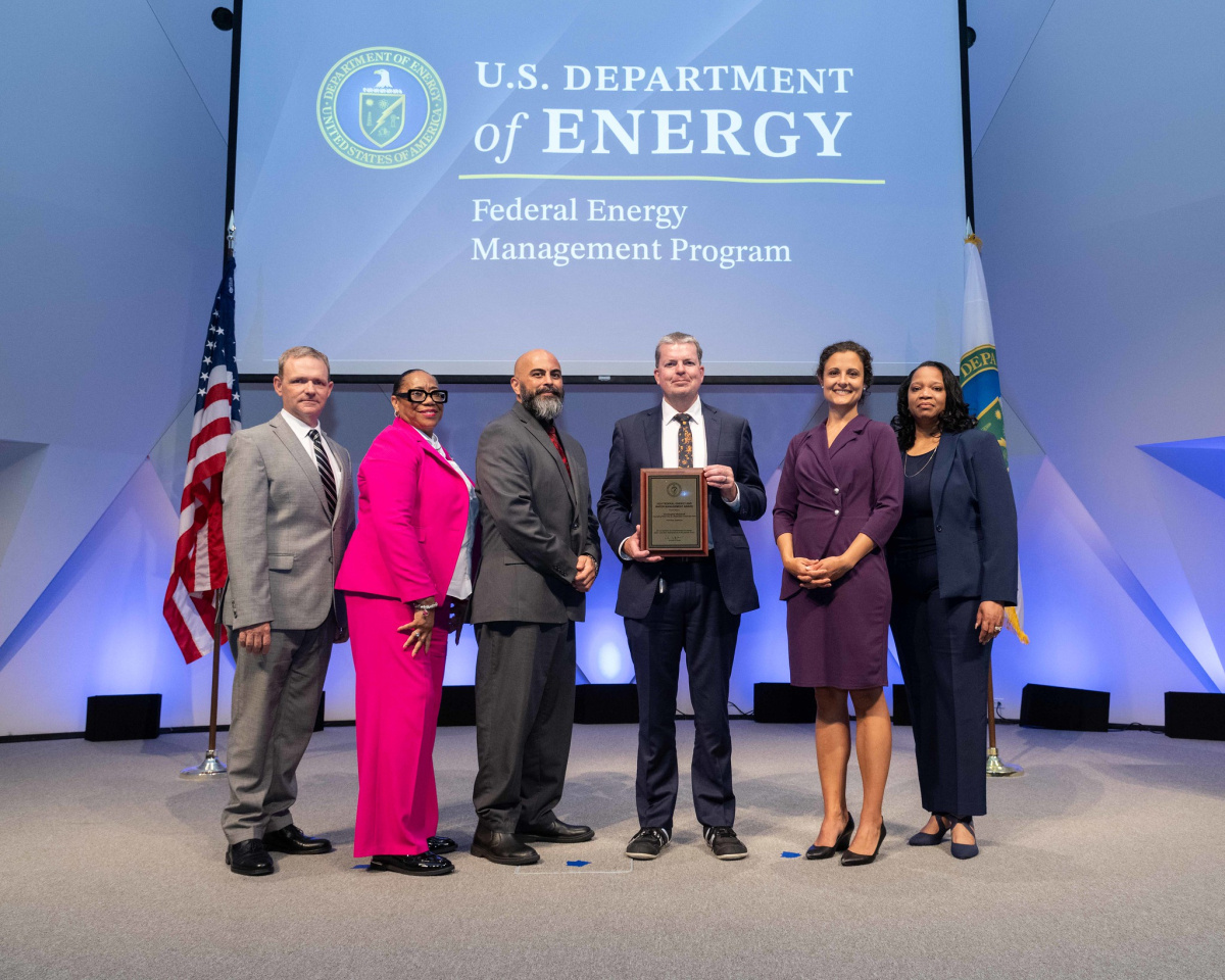 A group of people posing for a photo at the 2024 Federal Energy and Water Management Awards ceremony.