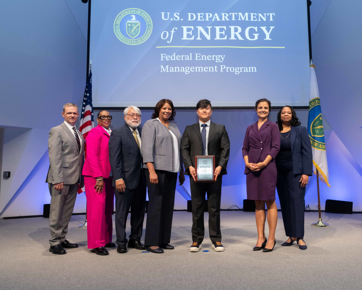 A group of people posing for a photo at the 2024 Federal Energy and Water Management Awards ceremony.