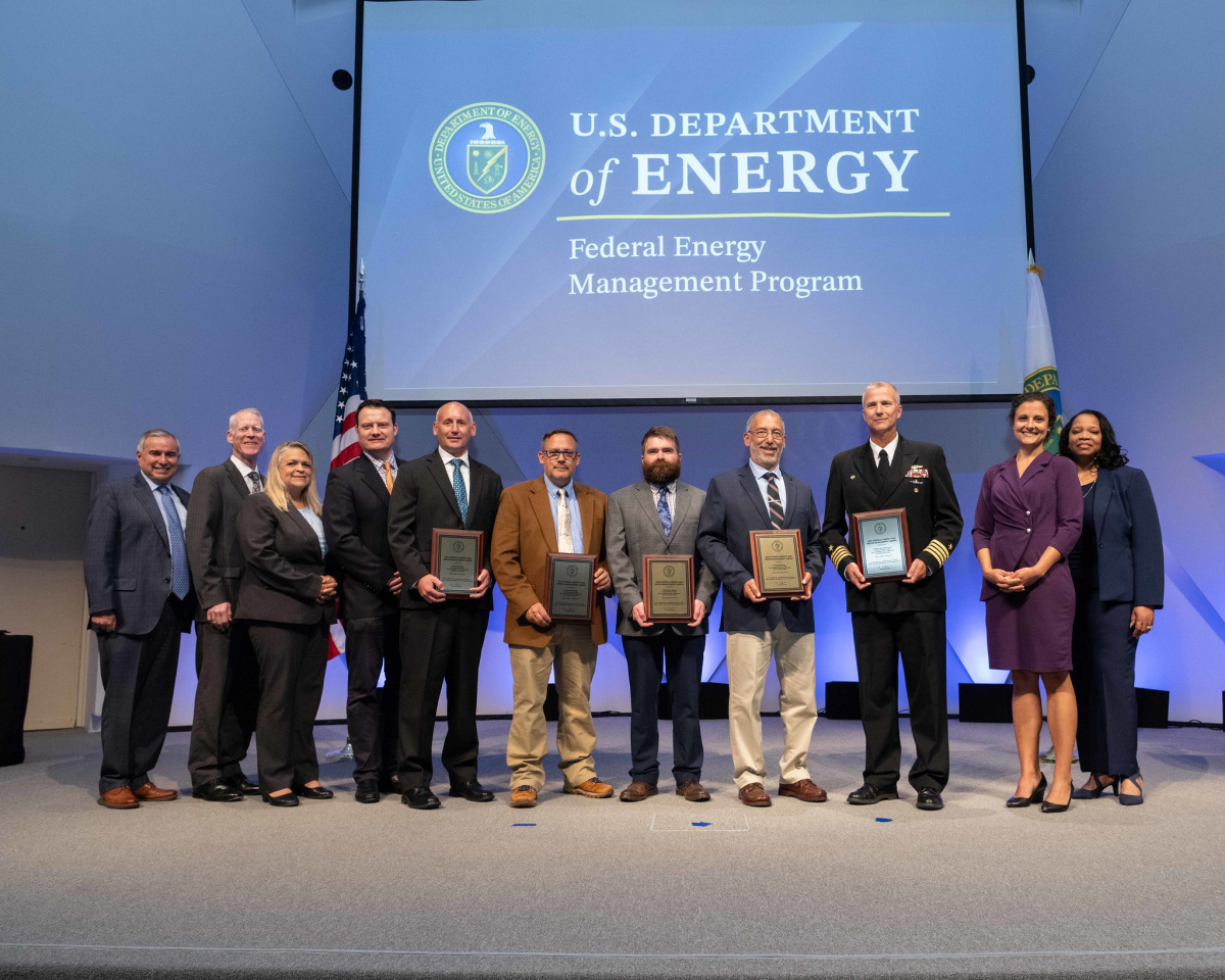 A group of people posing for a photo at the 2024 Federal Energy and Water Management Awards ceremony.
