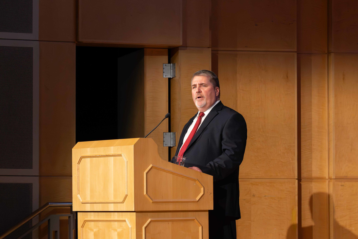 Man speaks at podium