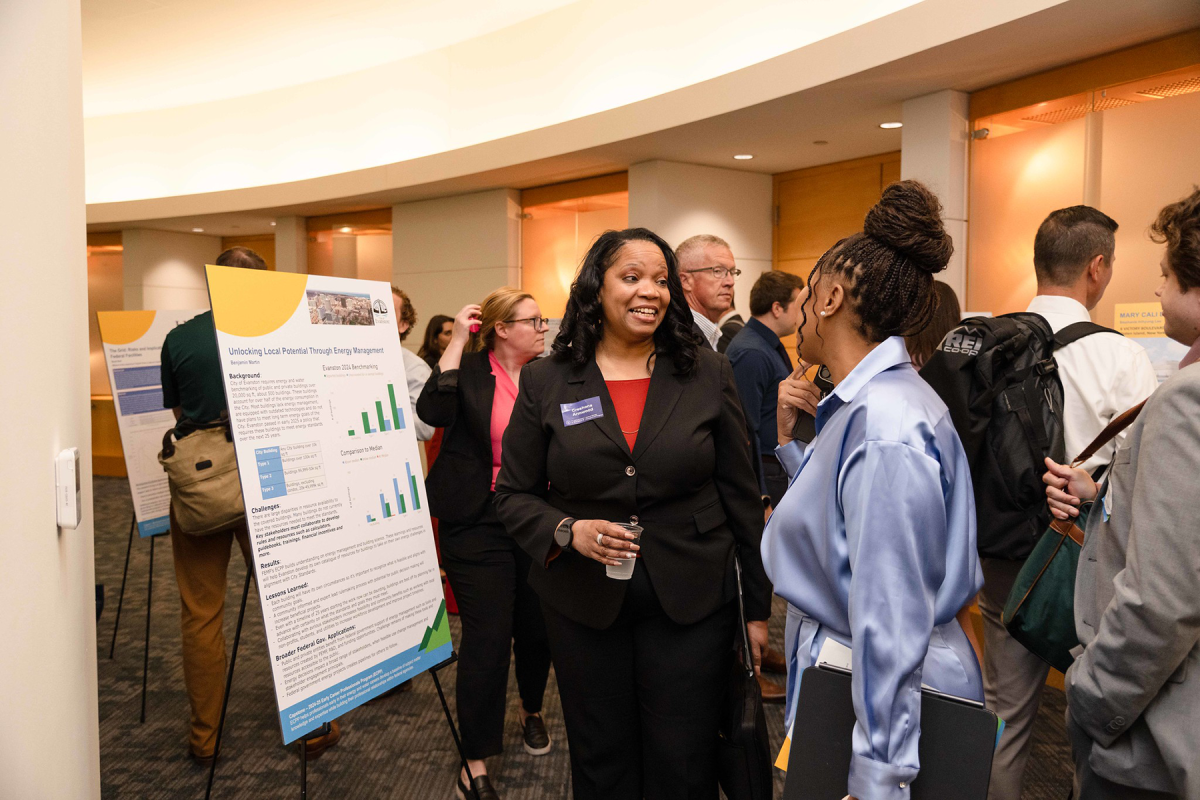 Attendees review projects developed by the latest cohort from the Early Career Professionals Program