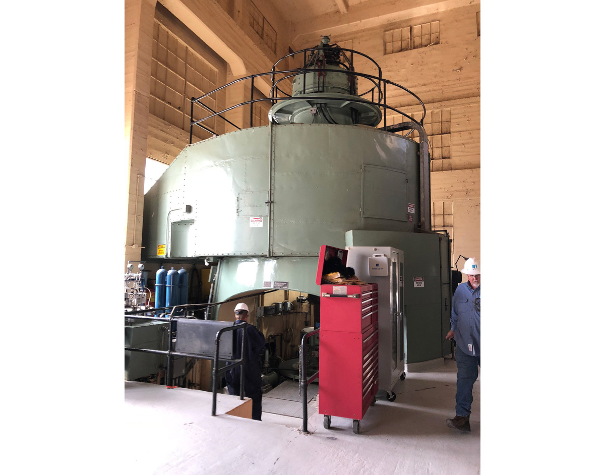 A large vertical-shaft hydroelectric generator inside the Kern Canyon powerhouse.