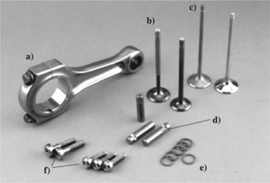 Example titanium auto parts: a) connecting rod – Ducati, b) intake and outtake valves, c) coated/uncoated valves, d) brake pins – Mercedes-Benz, e) brake sealing rings – Volkswagen, f) rim screws – Ronal & BBS. Photo courtesy of <em>Titanium and Titanium Alloys</em>, Leyens & Peters. Example titanium auto parts: a) connecting rod – Ducati, b) intake and outtake valves, c) coated/uncoated valves, d) brake pins