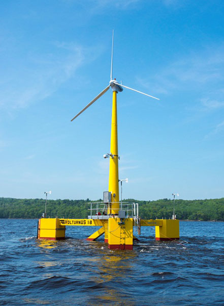 The VolturnUS 1:8 was deployed down the Penobscot River to Castine, Maine, on June 2, 2013. It is the first grid-connected, floating offshore wind turbine in the Americas. Photo courtesy of the University of Maine A 65-foot tall, 20-kilowatt wind turbine with a white rotor and a yellow tower on a floating platform in the ocean.