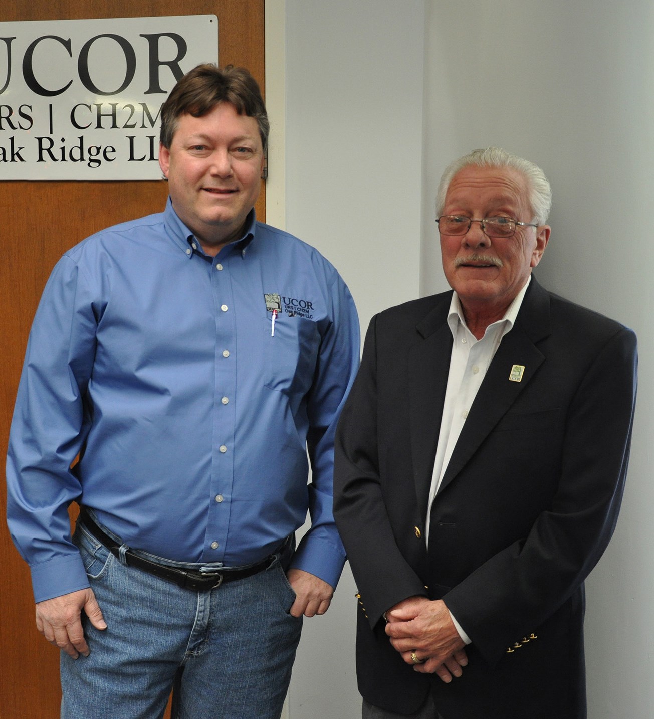 Photo of two men standing side-by-side.