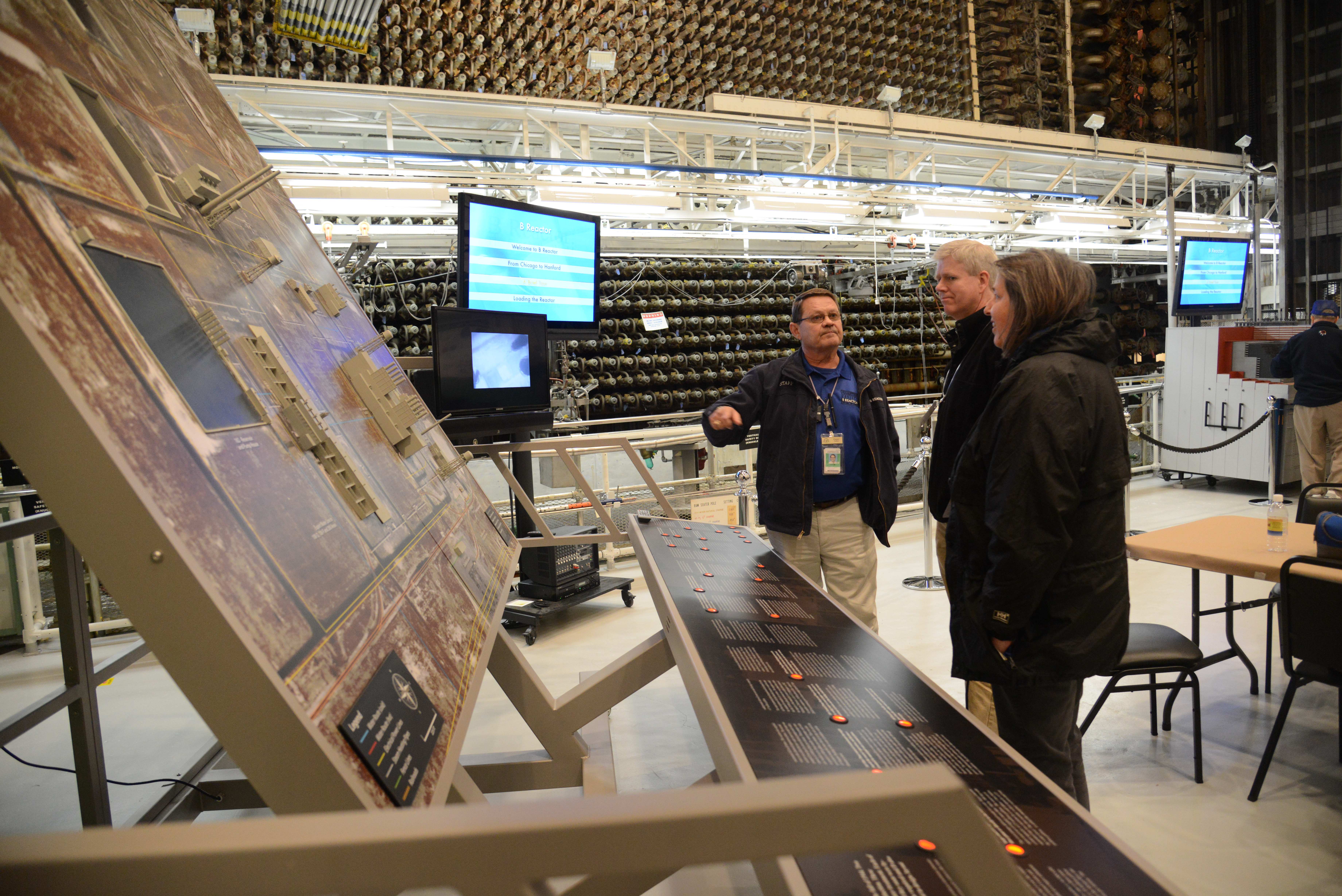 Team views exhibits in front of the face of the B Reactor Team views exhibits in front of the face of the B Reactor