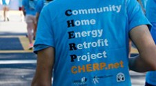 Photo of the back of a man wearing a T-shirt with the CHERP acronymn -- Community Home Energy Retrofit Project.