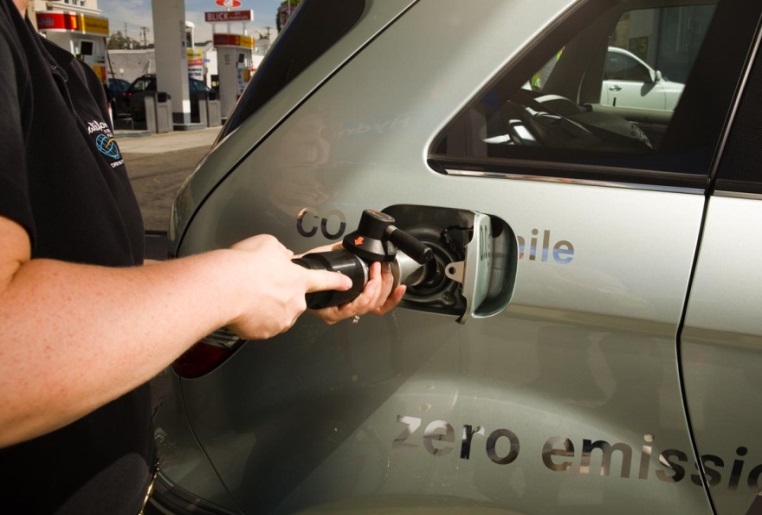 Hydrogen is dispensed to a fuel cell electric vehicle. Photo from the California Fuel Cell Partnership Photo of a person dispensing hydrogen into a vehicle fuel tank