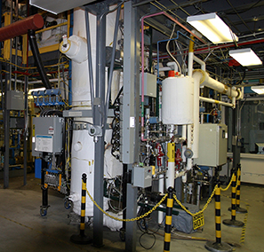 This Thermochemical Process Development Unit at the National Renewable Energy Laboratory (NREL) can pyrolyze biomass into bio-oil for conversion to hydrogen. Photo from NREL Photo of cylindrical reactor vessel and associated piping and equipment in the Thermochemical Process Development Unit at NREL