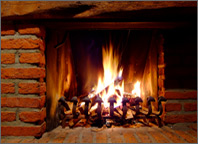Photo of a fire in a brick fireplace. Copyright iStockphoto.com/Oliver Malms.