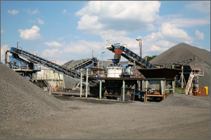 Image of conveyer belt and gravel at mining facility
