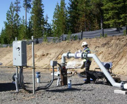 Image of worker testing the sump pump at the Newberry site. (Photo Credit: Lauren Boyd)