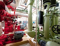 Photo of an equipment room in a high-rise commercial office building with red and green equipment.