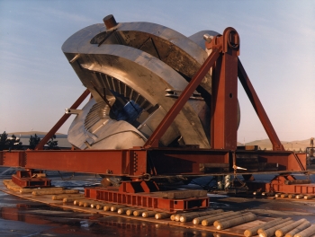 This 1981 photo shows the Mirror Fusion Test Facility (MFTF), an experimental magnetic confinement fusion device built using a magnetic mirror at Lawrence Livermore National Laboratory (LLNL). The MFTF functioned as the primary research center for mirror fusion devices.
The design consisted of a 64-meter-long vacuum vessel fitted with 26 coil magnets bonding the center of the vessel and two 400-ton yin-yang magnet mirrors at either end. The first magnet produced a magnetic field force equal to the weight of 30 jumbo jets hanging from the magnet coil. | Photo courtesy of Lawrence Livermore National Laboratory. This 1981 photo shows the Mirror Fusion Test Facility (MFTF), an experimental magnetic confinement fusion device built using a magnetic mirror at Lawrence Livermore National Laboratory (LLNL). The MFTF functioned as the primary research center for mirror fusion devices.
The design consisted of a 64-meter-long vacuum vessel fitted with 26 coil magnets bonding the center of the vessel and two 400-ton yin-yang magnet mirrors at either end. The first magnet produced a magnetic field force equal to the weight of 30 jumbo jets hanging from the magnet coil. | Photo courtesy of Lawrence Livermore National Laboratory.