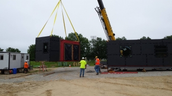 Missouri University of Science and Technology uses a crane to drop the house modules of Nest Home into place on campus after several months of construction in a warehouse. | Photo courtesy of Missouri University of Science and Technology. Missouri University of Science and Technology uses a crane to drop the house modules of Nest Home into place on campus after several months of construction in a warehouse. | Photo courtesy of Missouri University of Science and Technology.