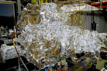 SLAC National Accelerator Laboratory uses massive quantities of aluminum foil to perform "bake out" of their equipment. In a typical bake out, the equipment is blanketed in foil, wrapped with electrical heat tape, and then covered in foil again. Heat tape is used to heat the metal chamber just enough to loosen any residues that could cause trouble. The aluminum foil helps spread the heat evenly. | Photo of SLAC SLAC National Accelerator Laboratory uses massive quantities of aluminum foil to perform "bake out" of their equipment. In a typical bake out, the equipment is blanketed in foil, wrapped with electrical heat tape, and then covered in foil again. Heat tape is used to heat the metal chamber just enough to loosen any residues that could cause trouble. The aluminum foil helps spread the heat evenly. | Photo of SLAC