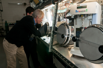 Argonne scientists Ira Bloom (front) and Javier Bareño prepare a sample of battery materials for Raman spectroscopy, which is used to gather information regarding the nature of the materials present in the sample. | Photo courtesy of Argonne National Laboratory. Argonne scientists Ira Bloom (front) and Javier Bareño prepare a sample of battery materials for Raman spectroscopy, which is used to gather information regarding the nature of the materials present in the sample. | Photo courtesy of Argonne National Laboratory.