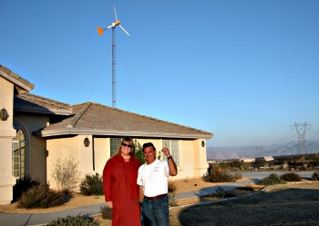 Homeowner Andrea Mitchel, with installer Joe Guasti, proudly shows off small wind turbine installed in Oak Hills, CA. | Photo by Karin Sinclair, National Renewable Energy Laboratory. Homeowner Andrea Mitchel, with installer Joe Guasti, proudly shows off small wind turbine installed in Oak Hills, CA. | Photo by Karin Sinclair, National Renewable Energy Laboratory.